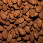 A detailed close-up view of raw almonds, showcasing the texture and natural color.